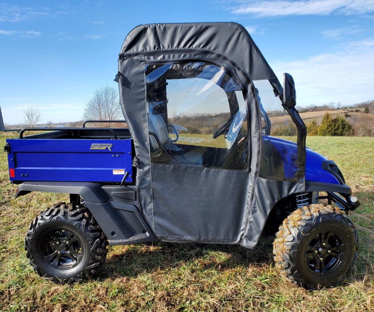 A blue utility vehicle with a cover on it's back.