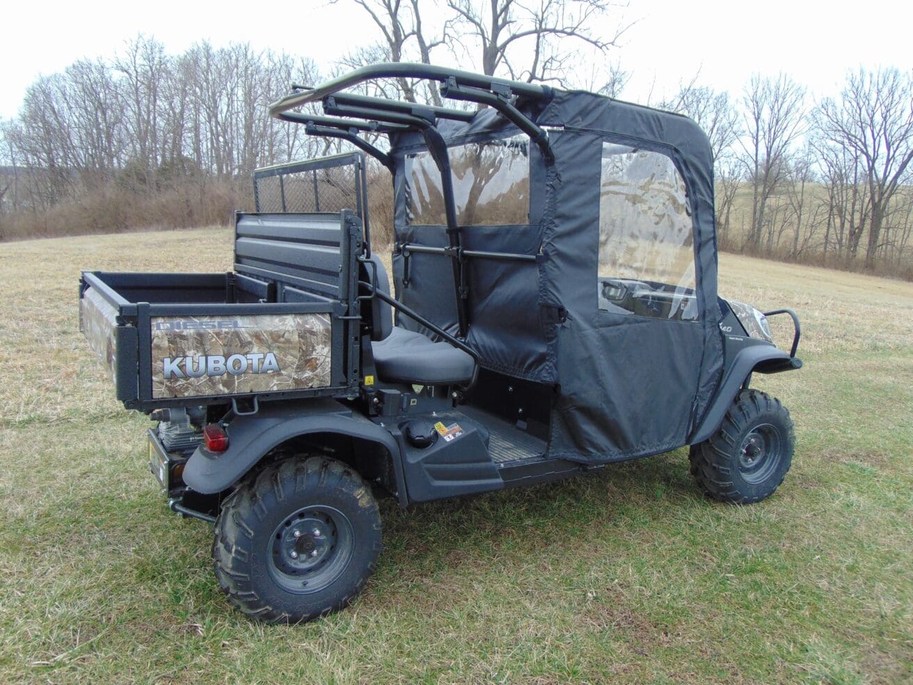 A black utility vehicle with a cover on it.