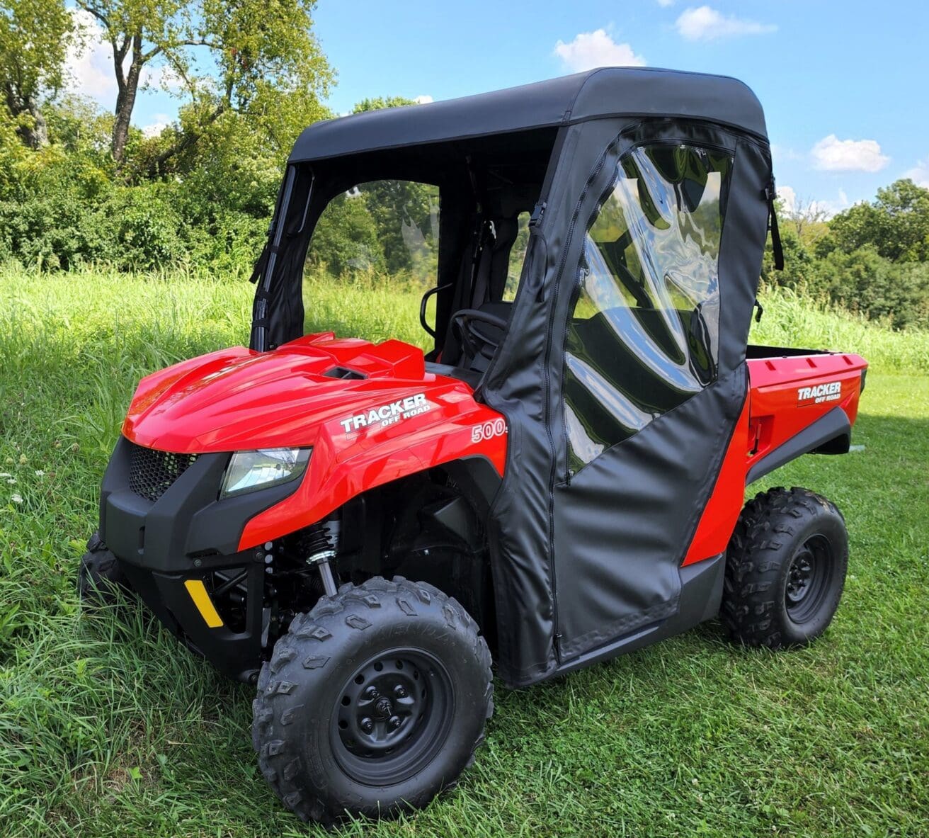 A red utility vehicle with a black cover.