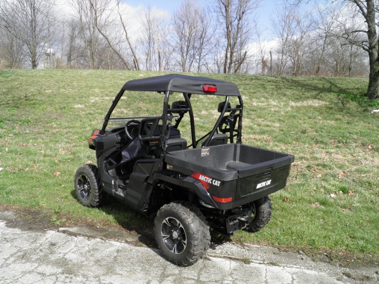 A black utility vehicle parked on the side of a road.