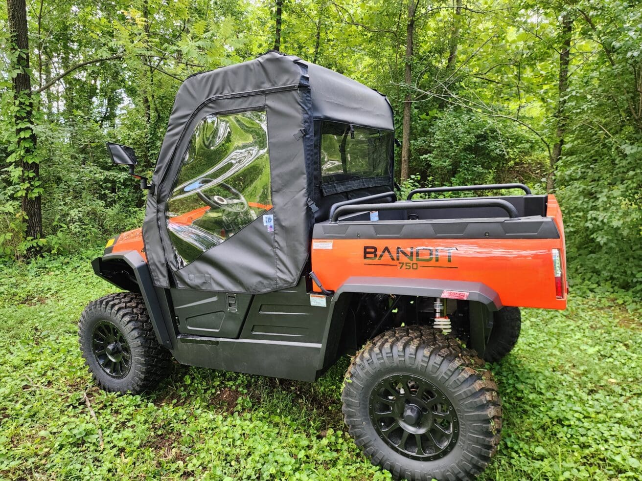 A red utility vehicle parked in the grass.