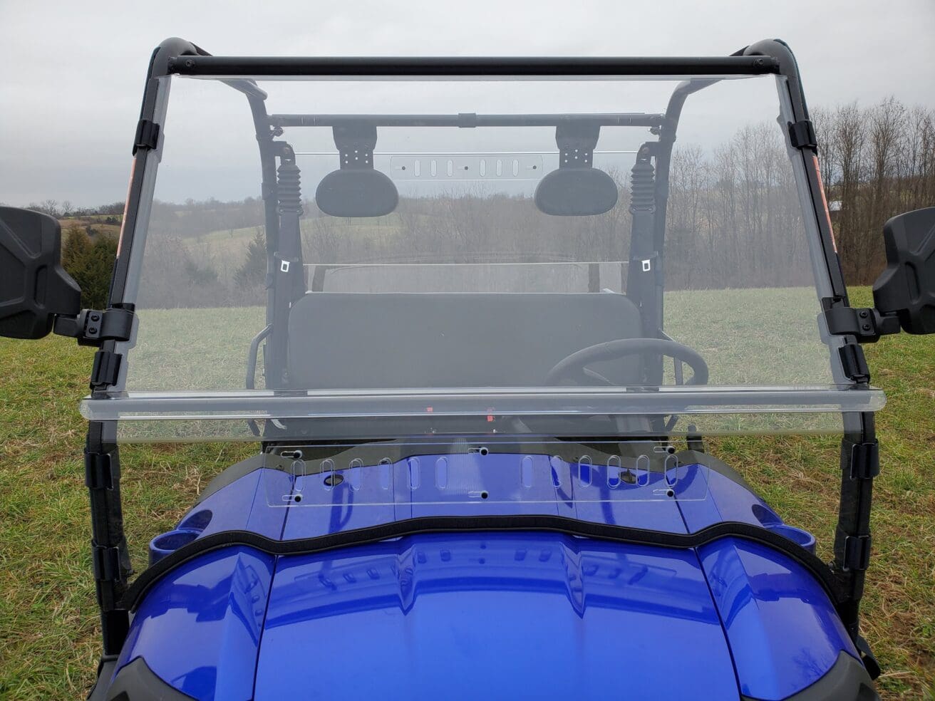 A blue utility vehicle with its windshield up.