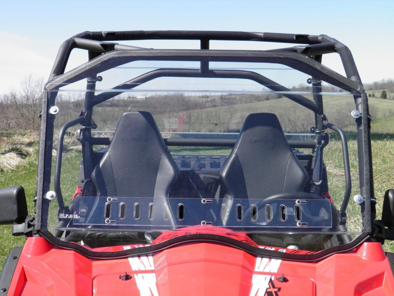 A red atv with two seats and a black back.