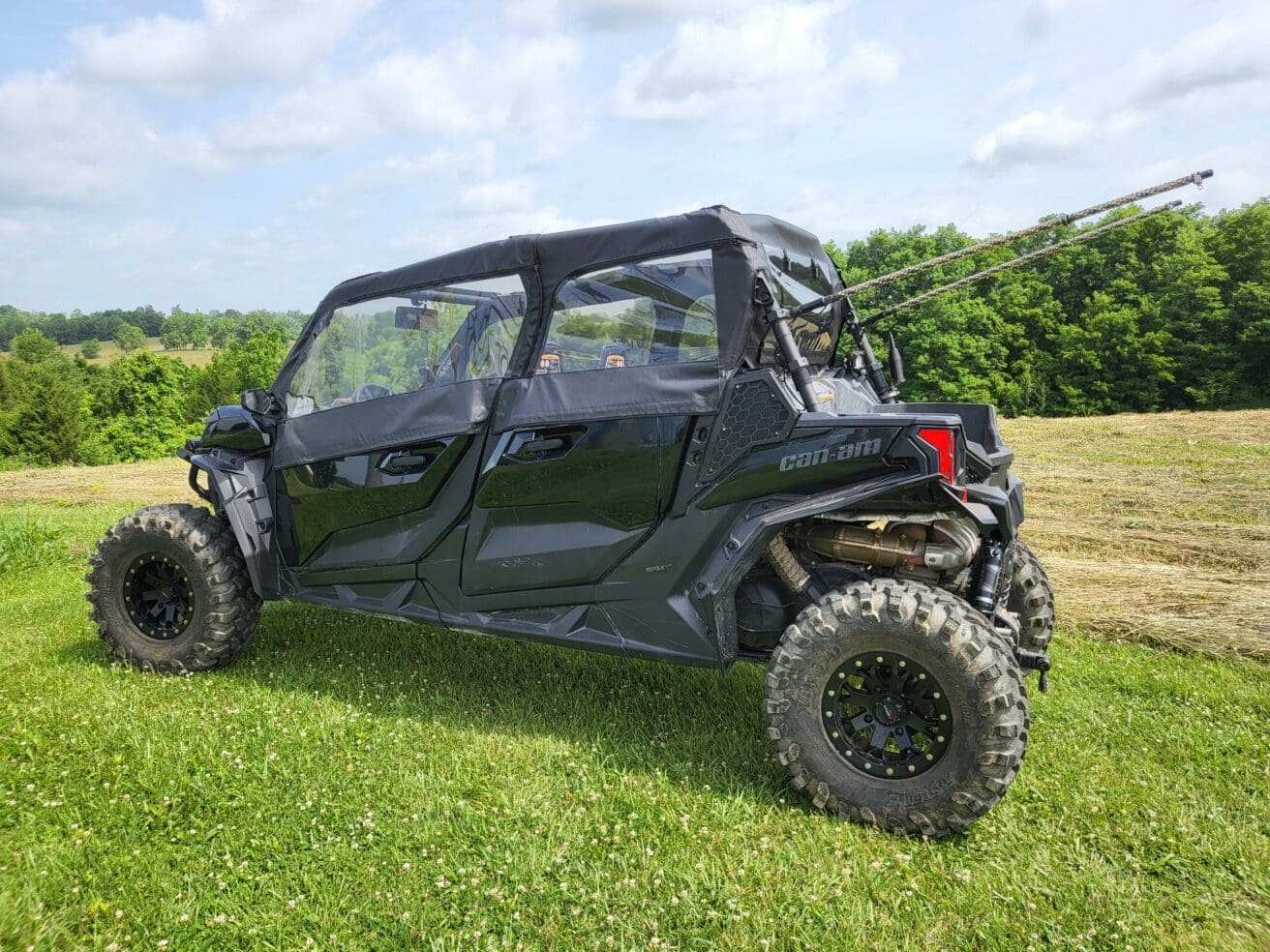 A black four-wheeled vehicle parked in the grass.
