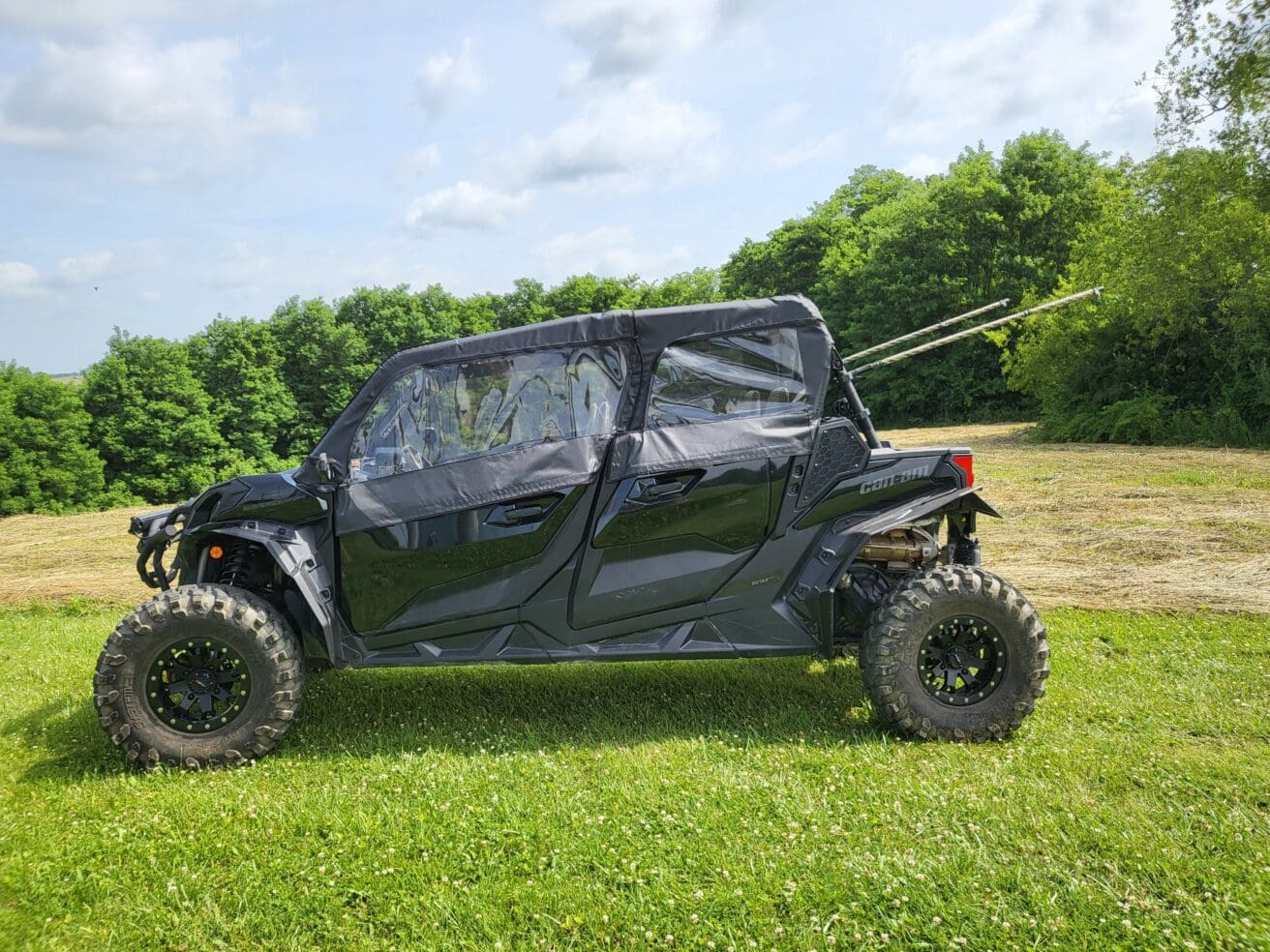 A black four-wheeled vehicle parked in the grass.