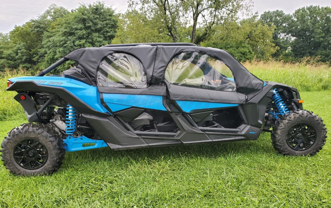 A blue and black four wheeler parked in the grass.