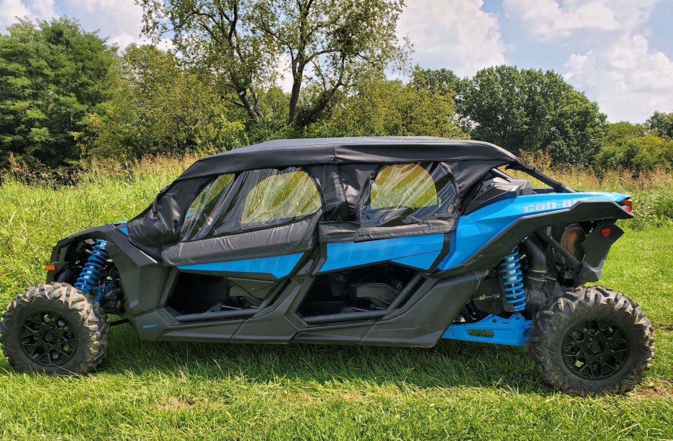 A blue and black car is parked in the grass.