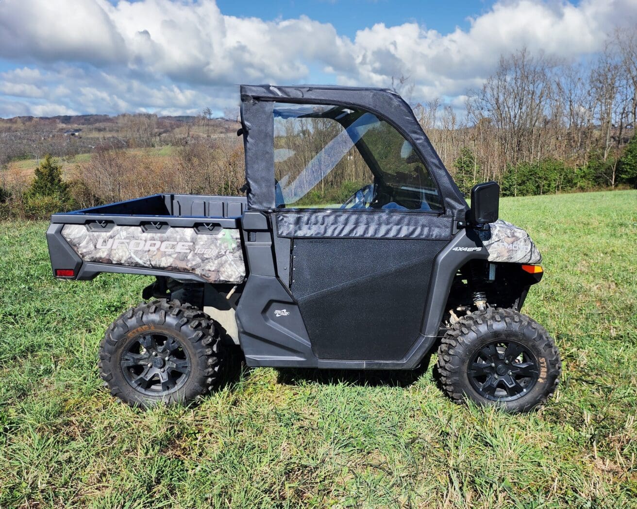 A black utility vehicle parked in the grass.