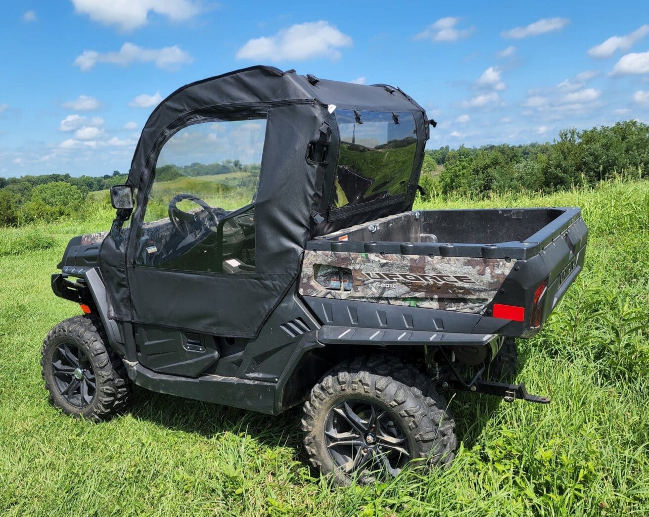 A black utility vehicle parked in the grass.