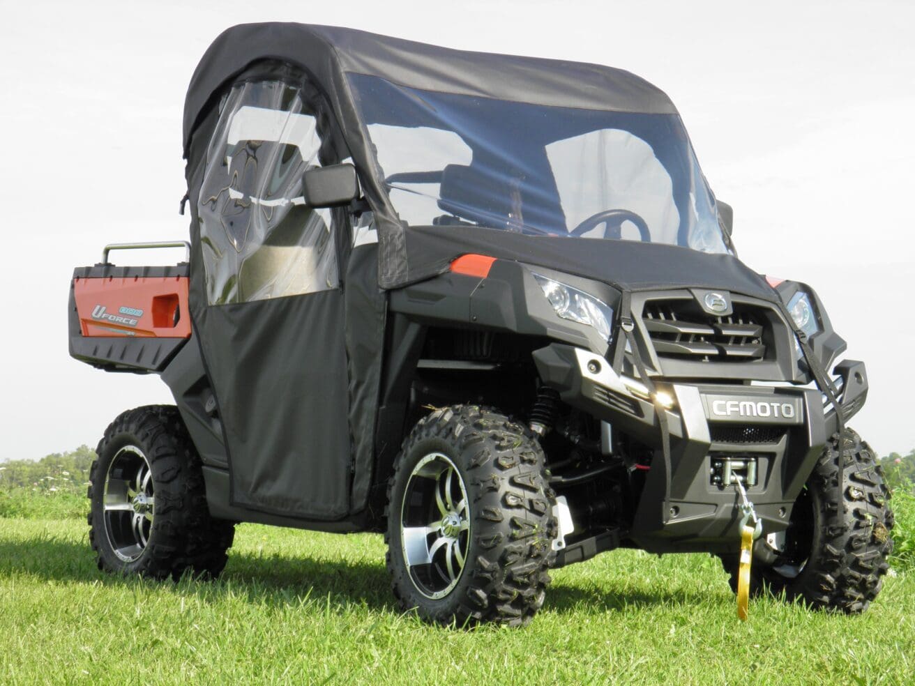 A black utility vehicle parked in the grass.