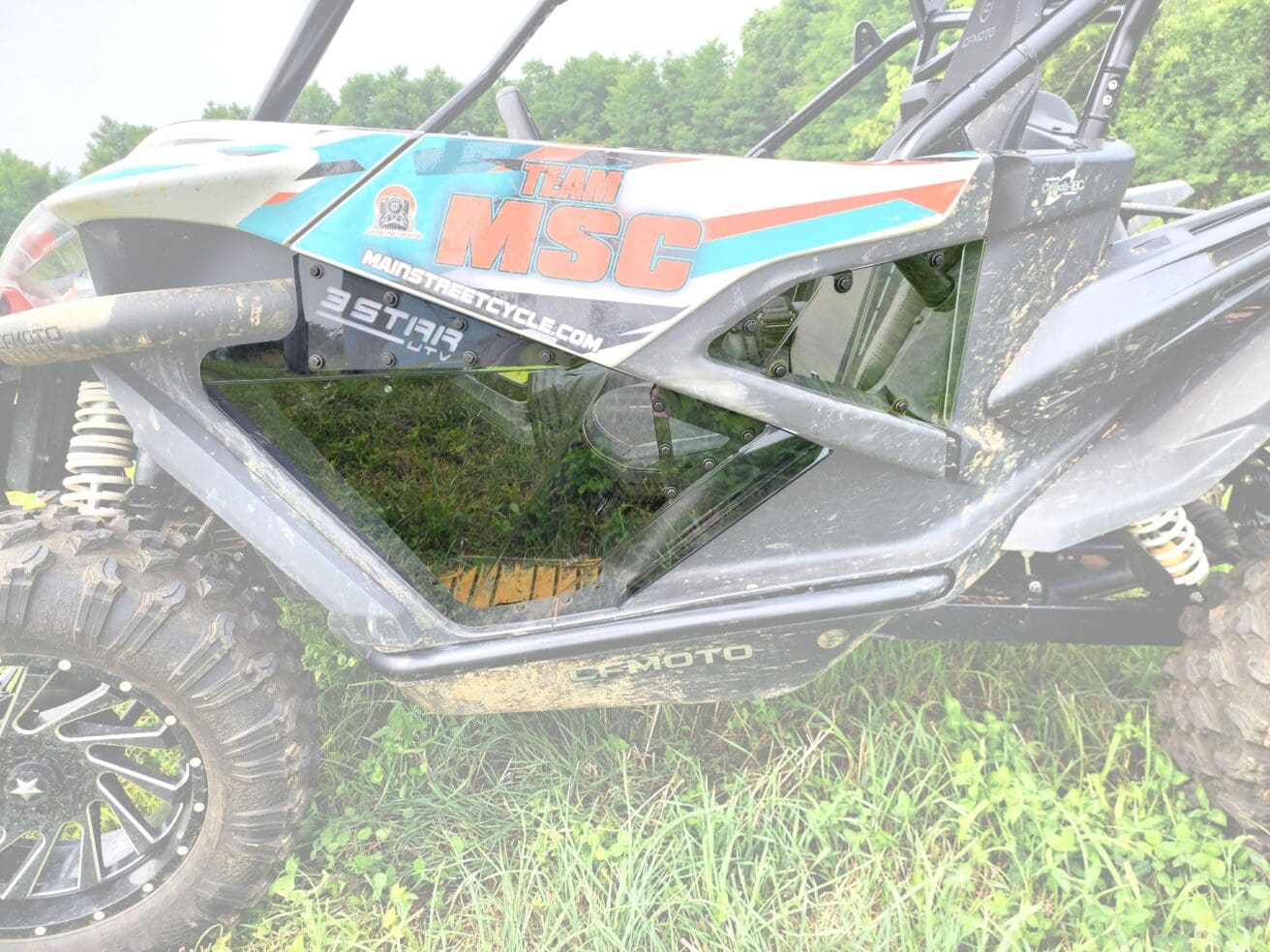 A dirt bike that is sitting in the grass.