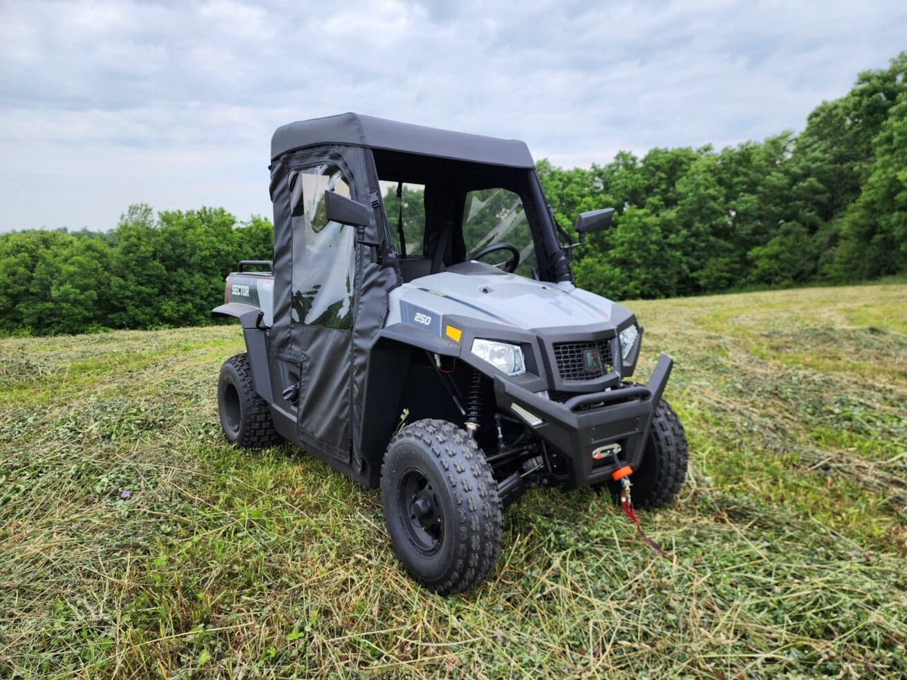 A gray utility vehicle parked in the grass.