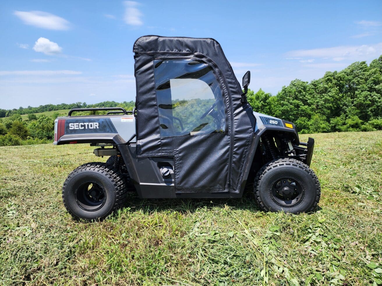 A black utility vehicle parked in the grass.
