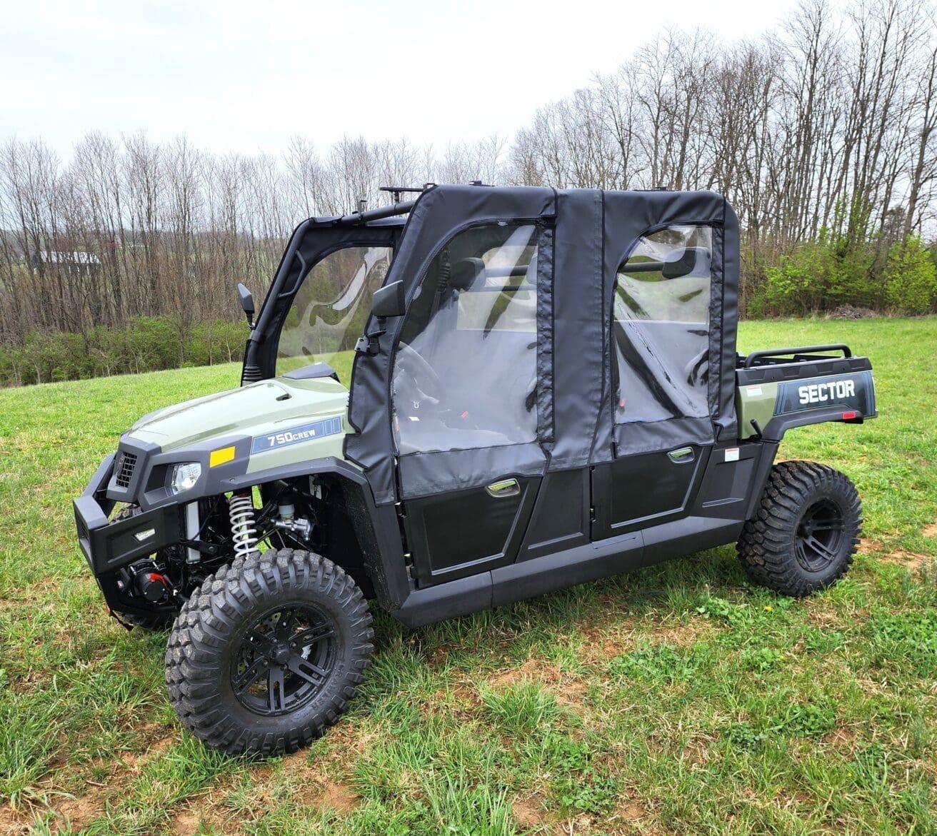 A black and silver utility vehicle parked in the grass.