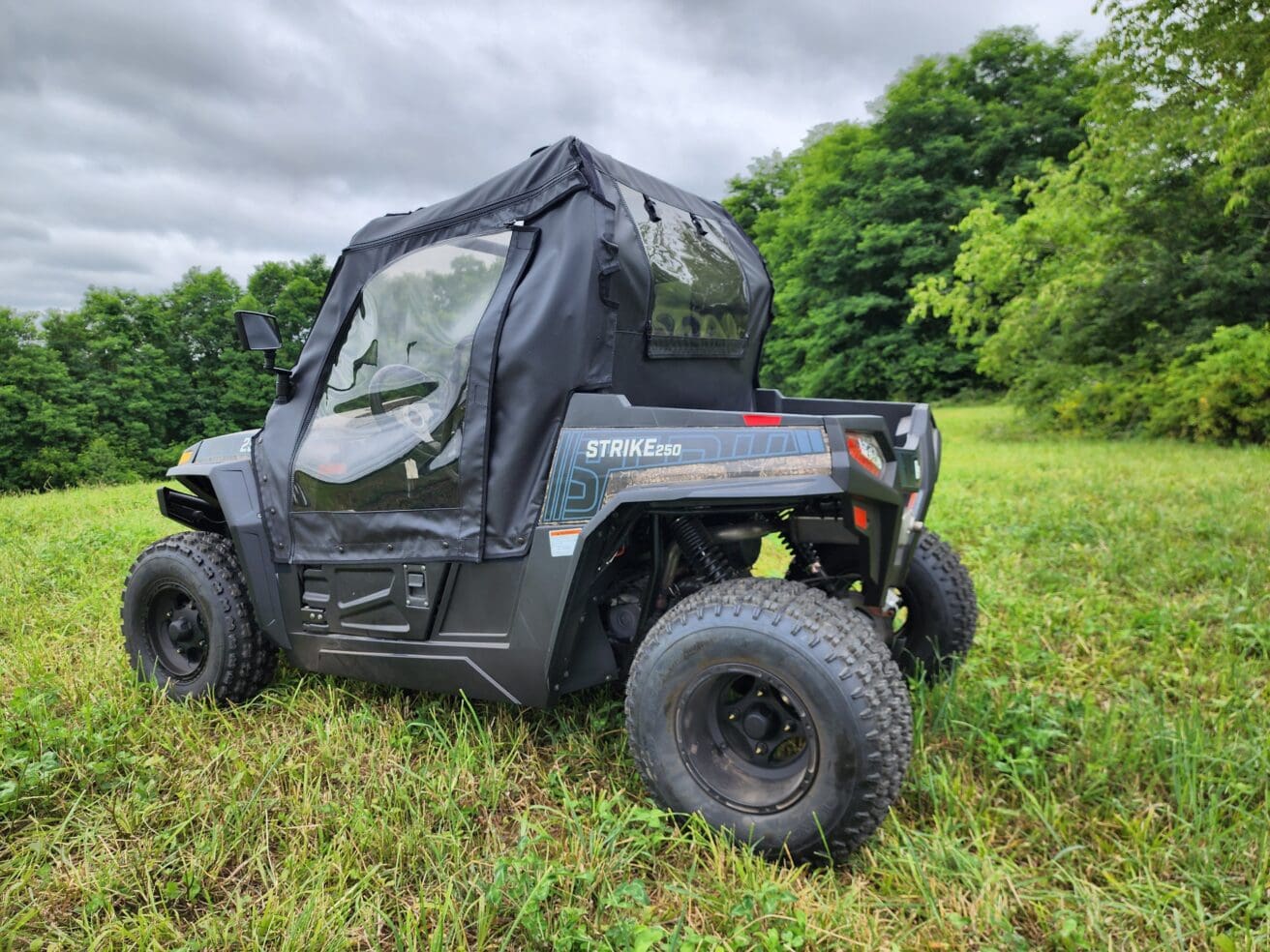 A black utility vehicle parked in the grass.