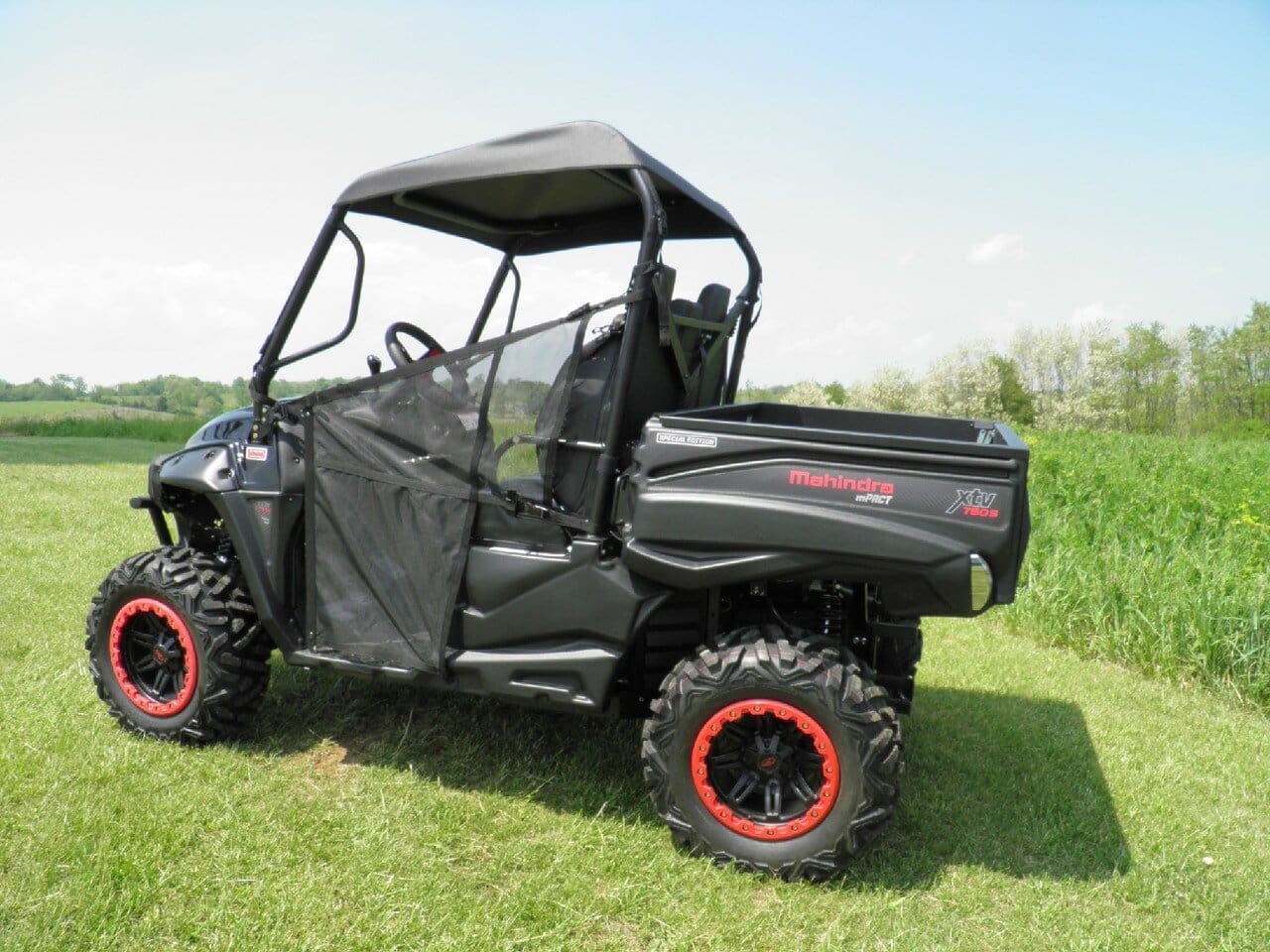 A black utility vehicle parked in the grass.