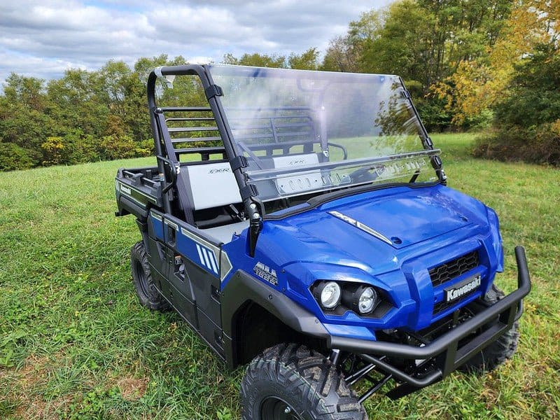 A blue utility vehicle parked in the grass.