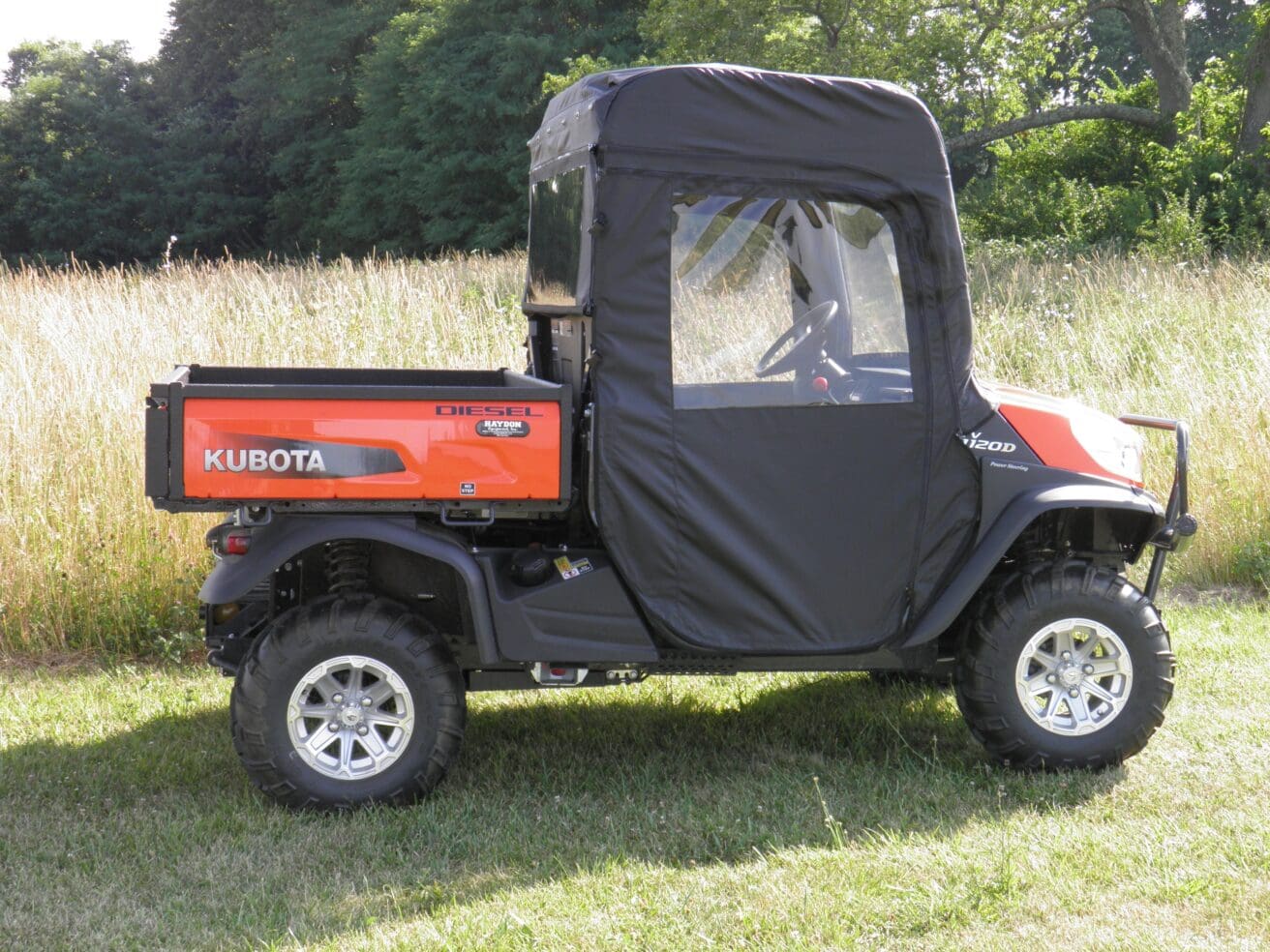 A red utility vehicle with a black cover on it's back.