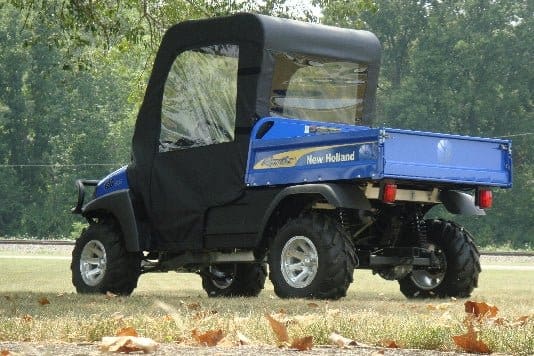 A blue utility vehicle parked in the grass.