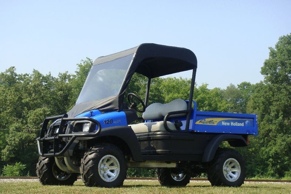 A blue utility vehicle parked in the grass.