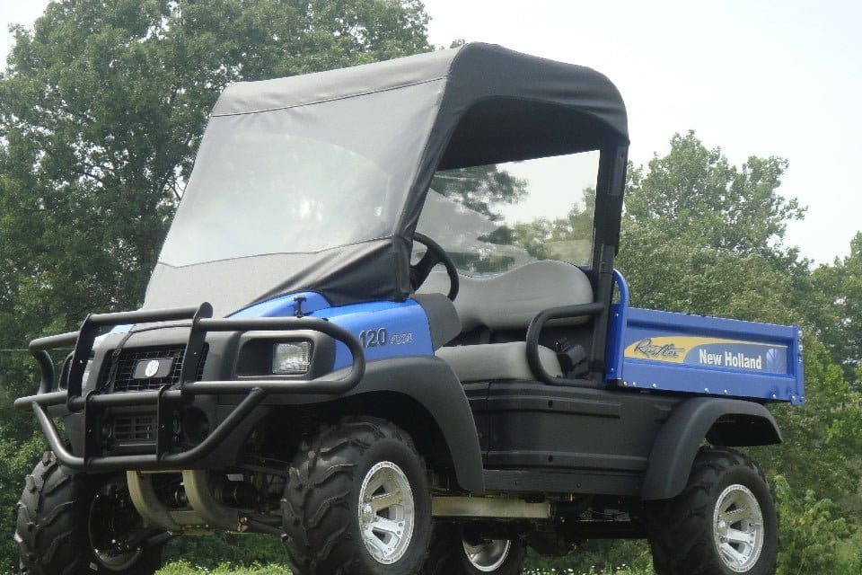 A blue utility vehicle parked in the grass.