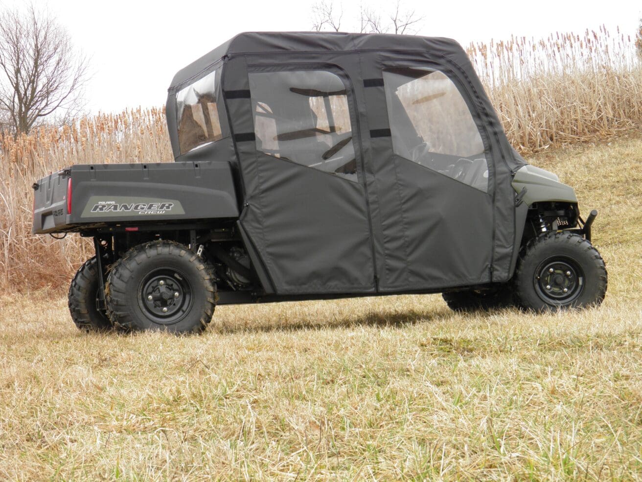 A black utility vehicle parked in the grass.