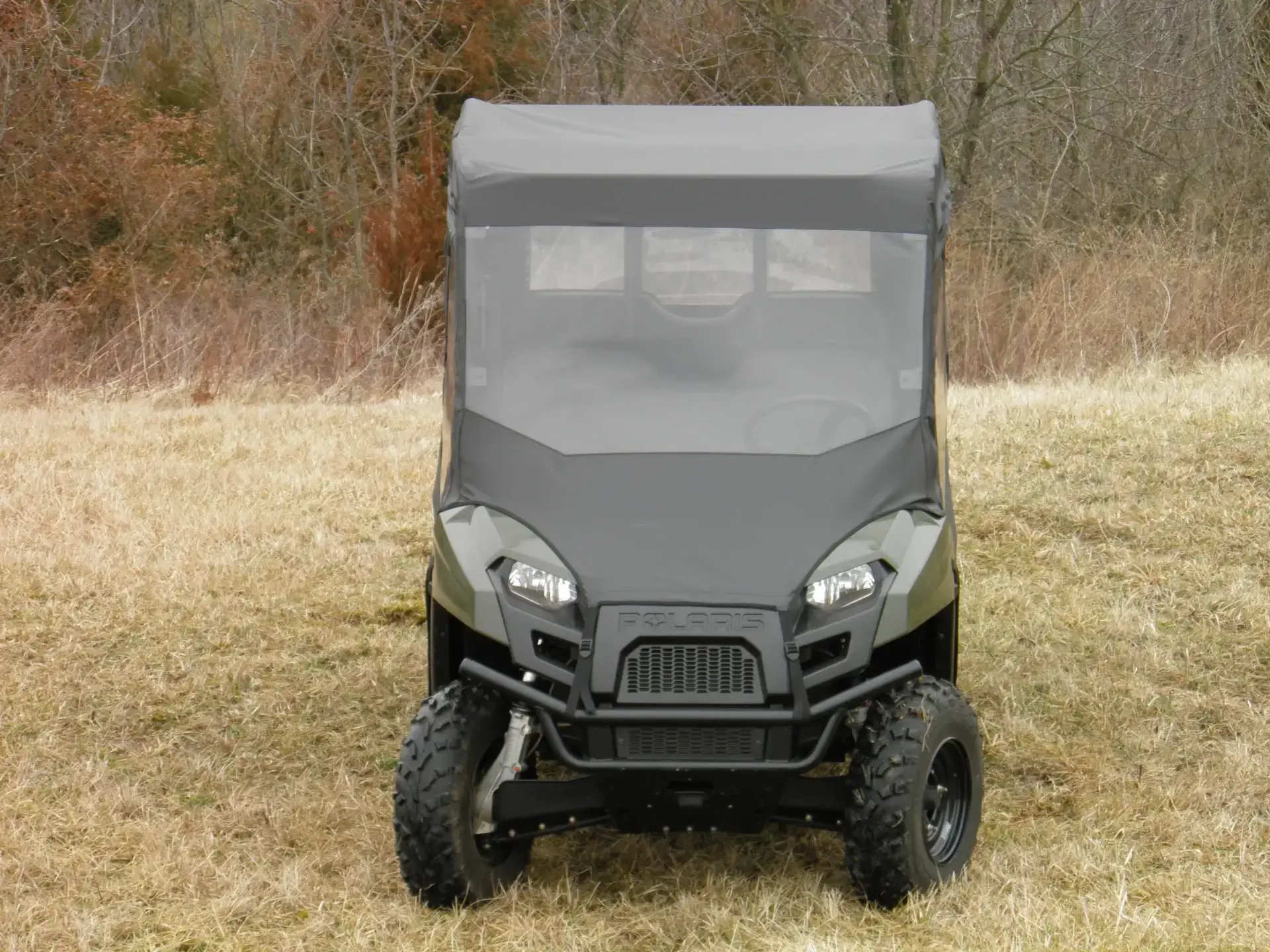 A black utility vehicle parked in the grass.
