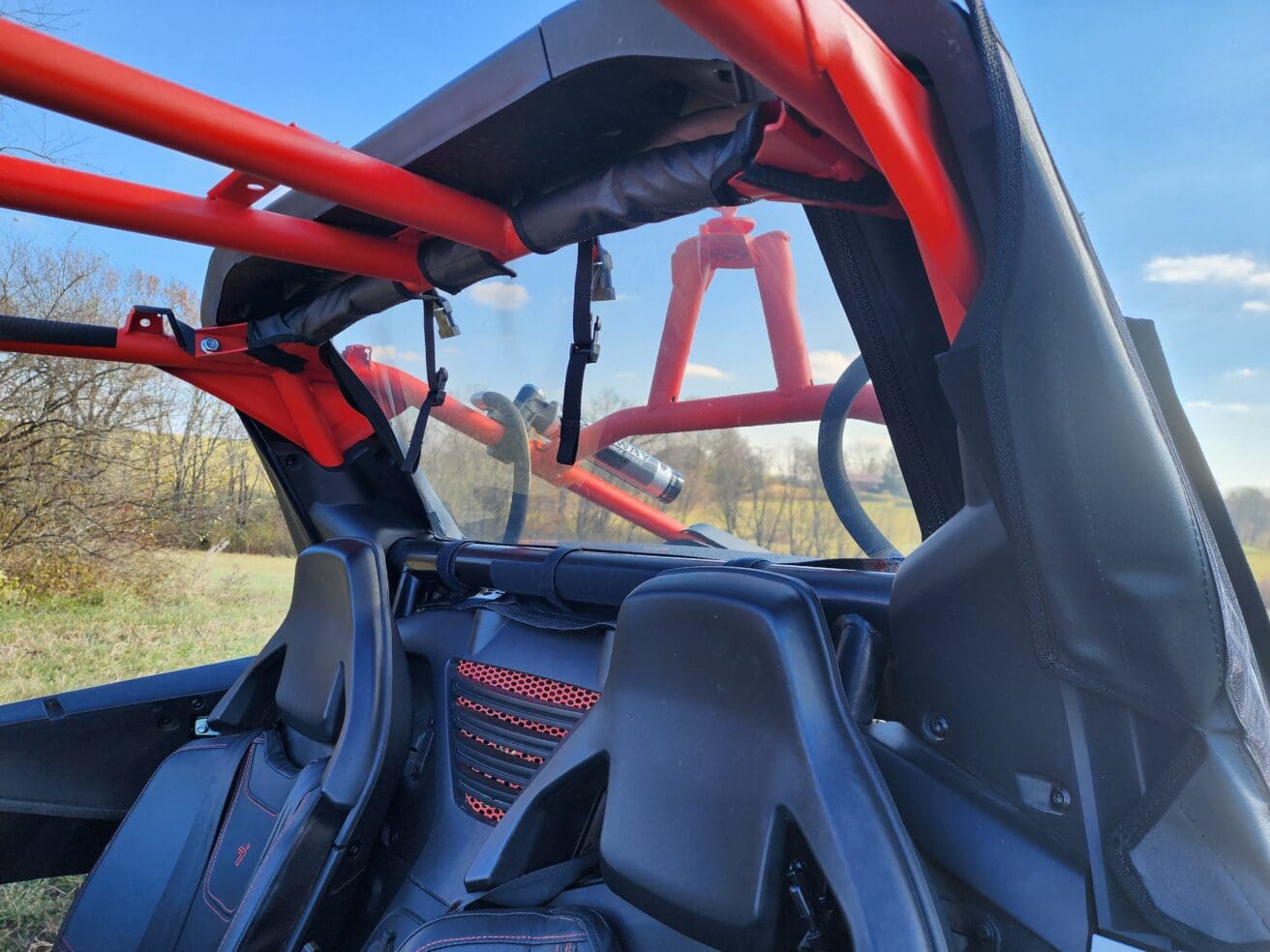 A view of the back of a vehicle with a seat and steering wheel.