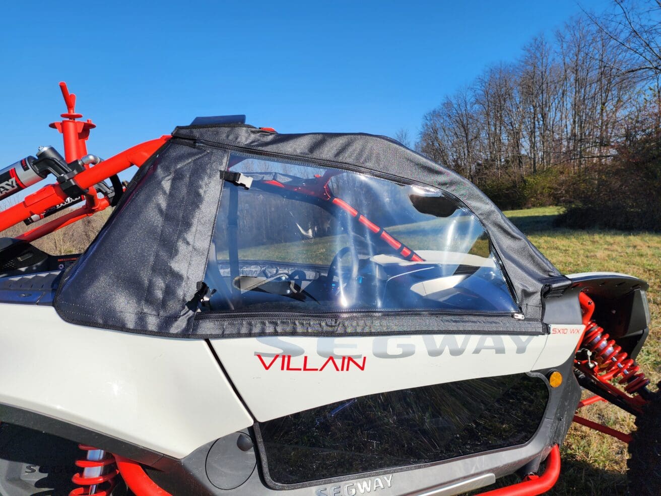 A car with the back door open and a windshield.