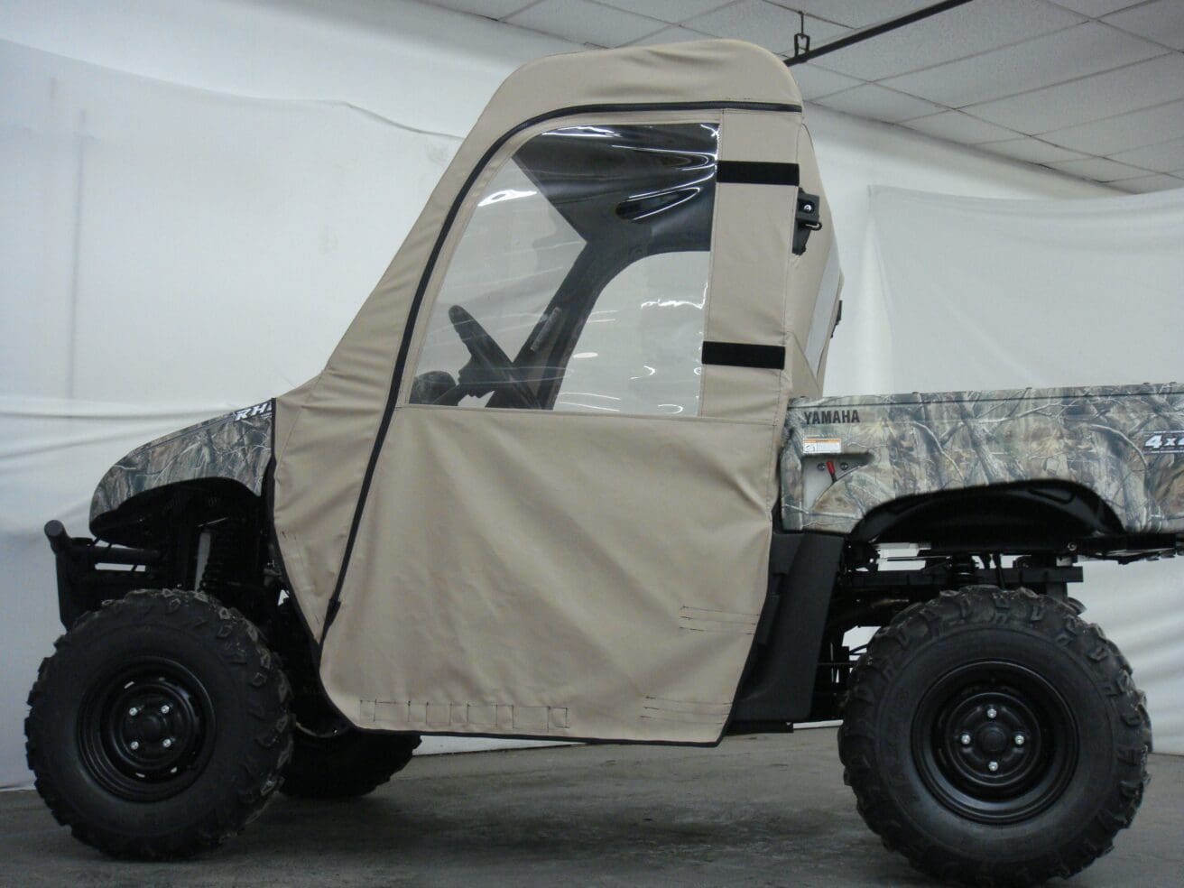 A small utility vehicle with a cover on it.