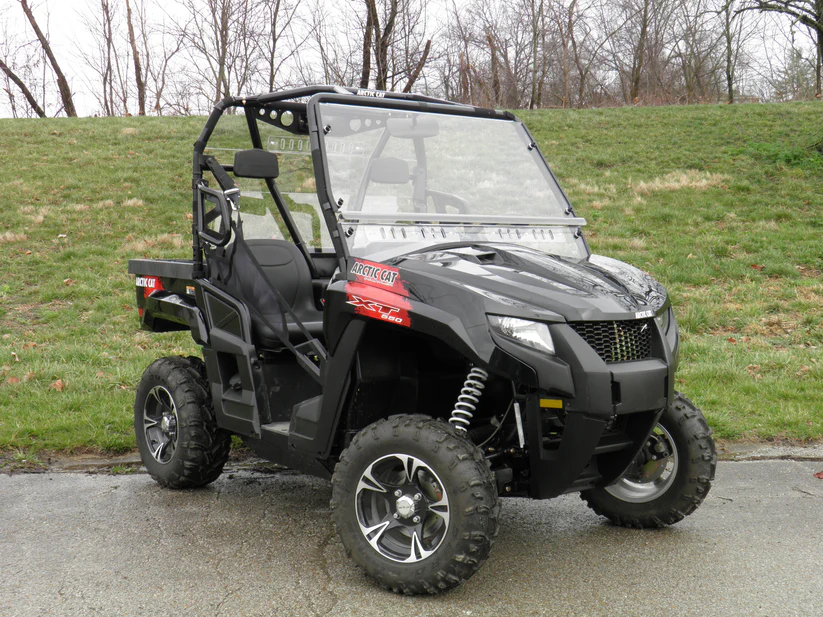 Black off-road utility vehicle on grass.
