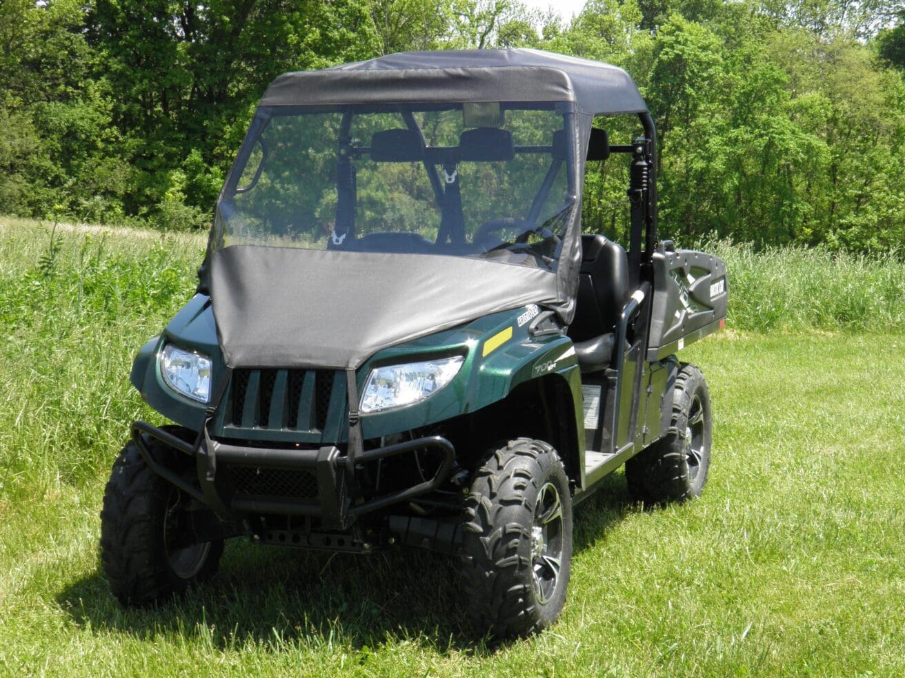 Off-road utility vehicle parked on grass.