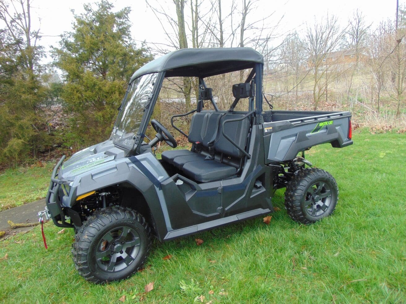 Off-road utility vehicle on grassy field.