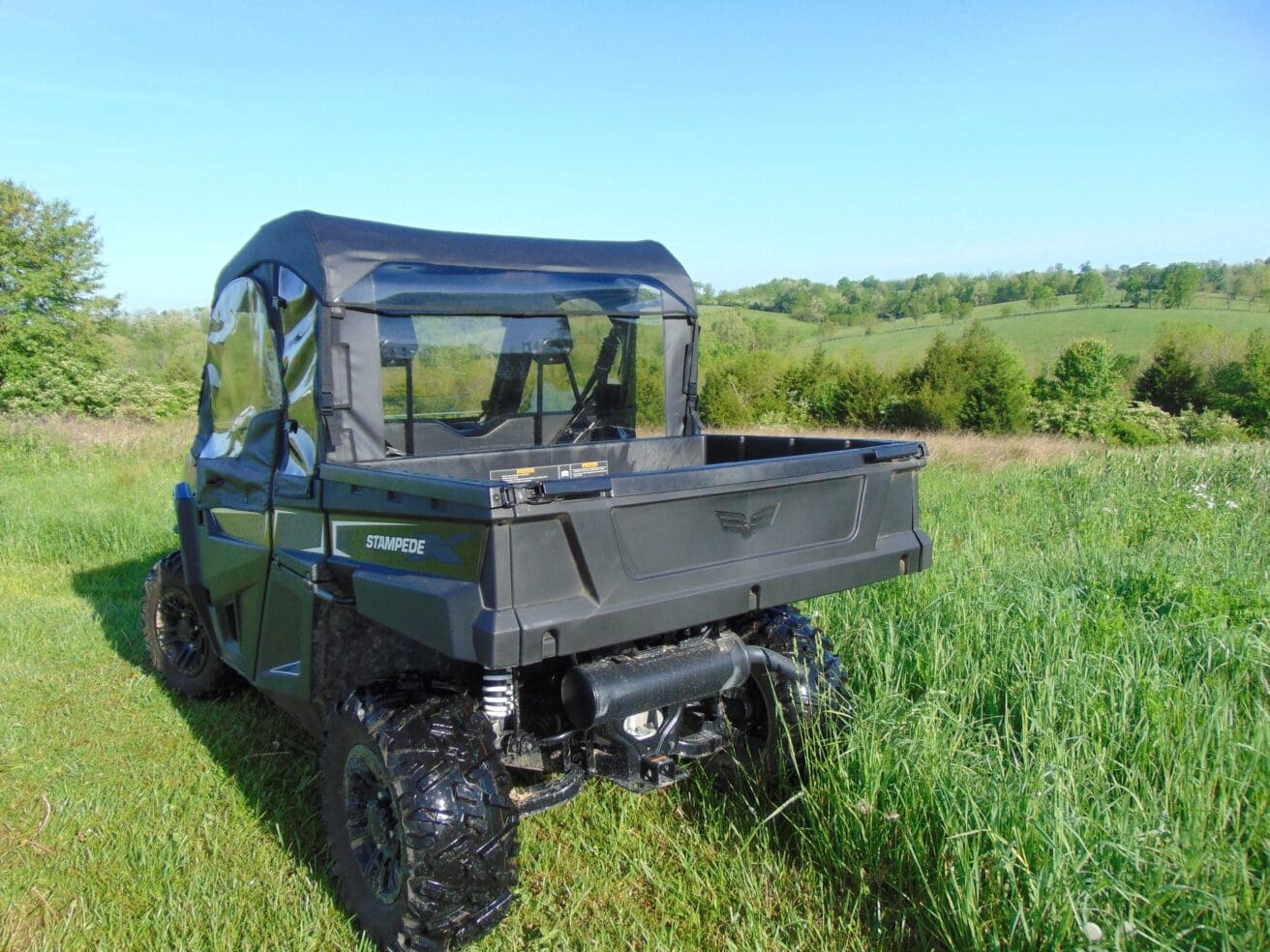 Off-road vehicle in grassy field.