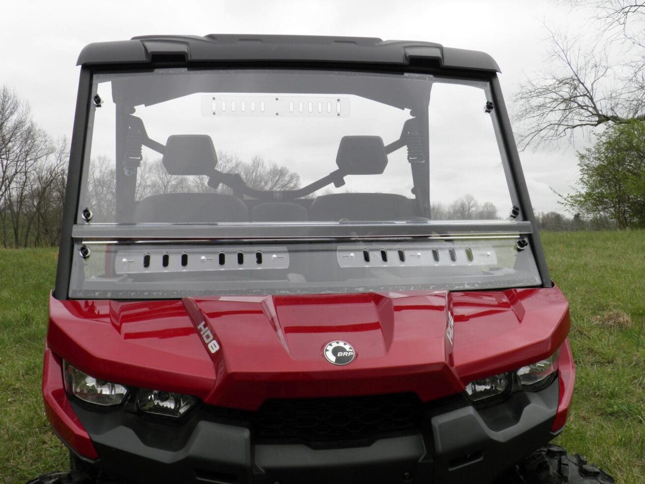 Red off-road vehicle front view outdoors.