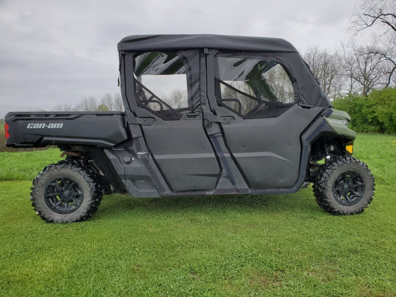 Black off-road vehicle on grassy field.