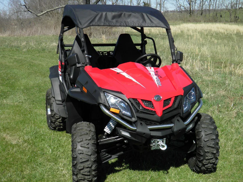 Red off-road vehicle on grassy field.