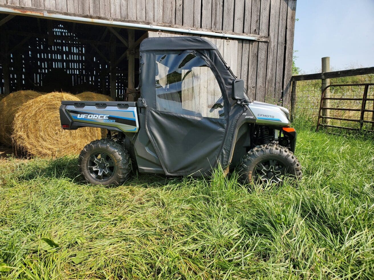 Utility vehicle parked near a barn.