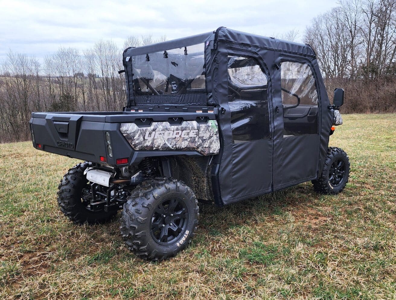 Off-road utility vehicle in grassy field.