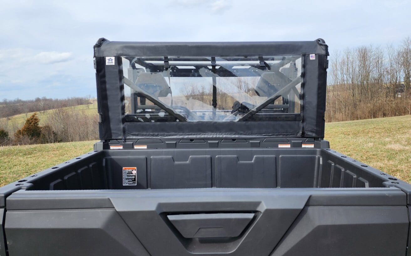 Black truck bed with clear rear window.