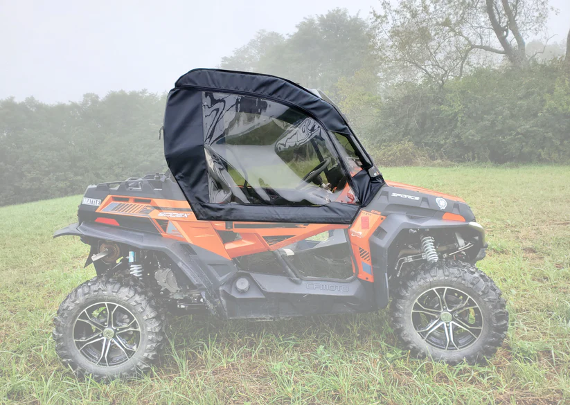 ATV with a black canopy on grass.