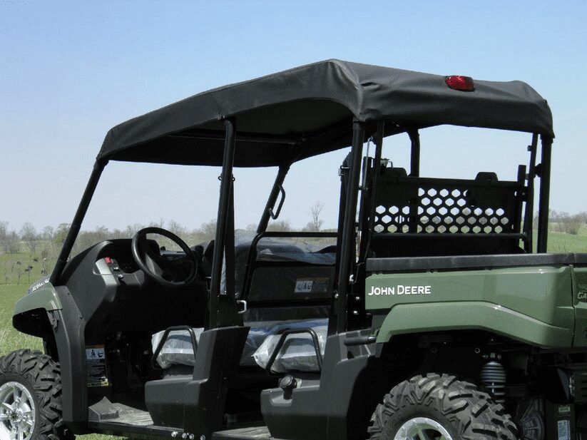 John Deere utility vehicle in grassy field.