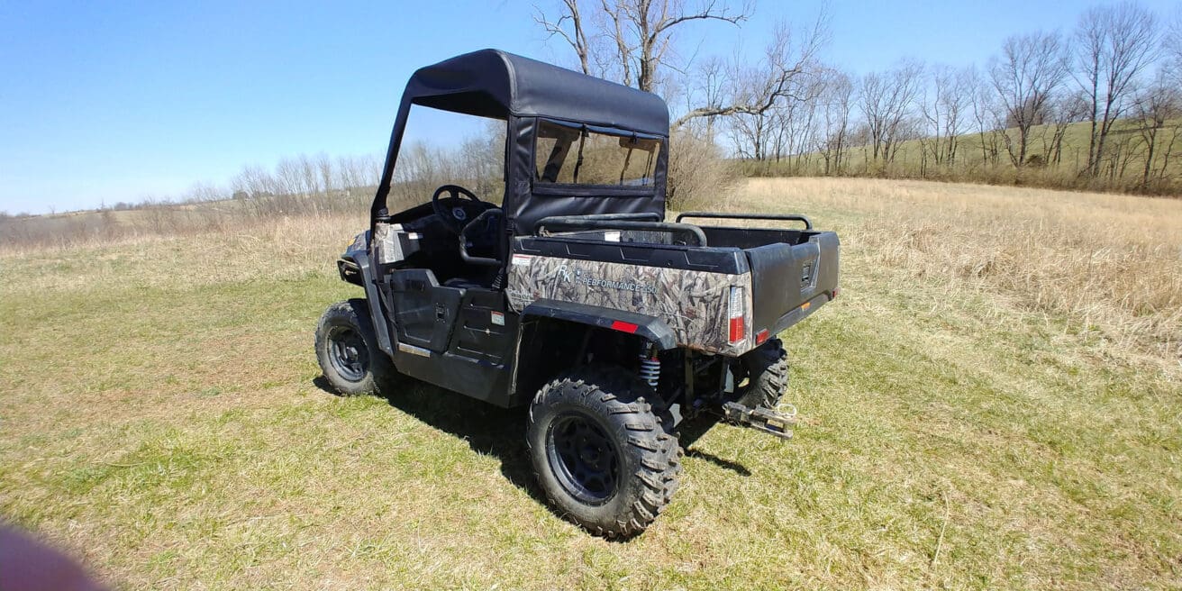 Off-road vehicle parked in grassy field.