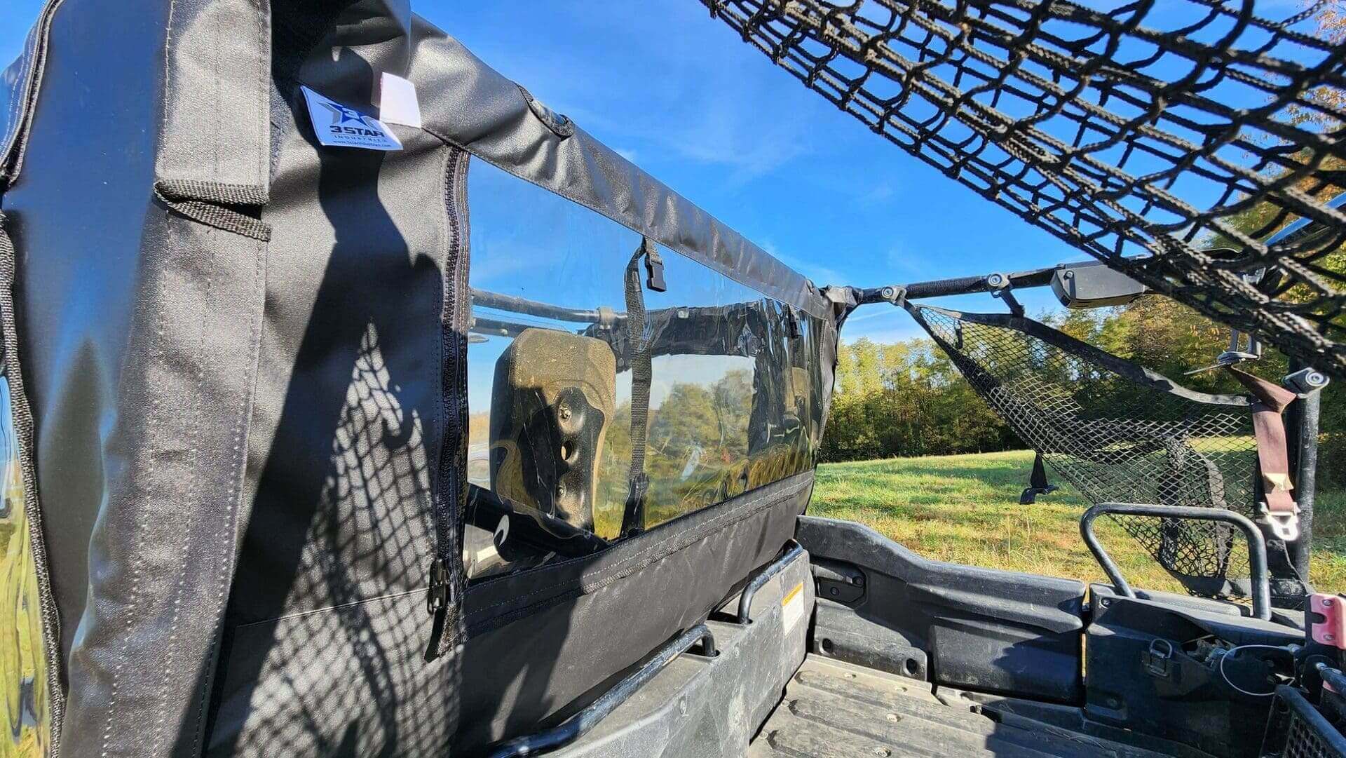 Utility vehicle with protective netting and cover.
