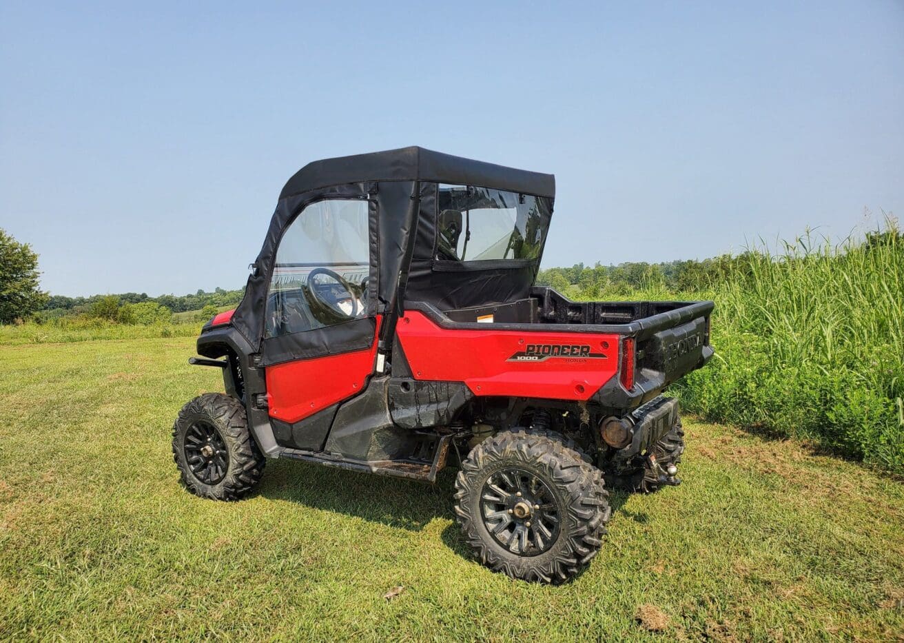 Red utility vehicle on grassy field.