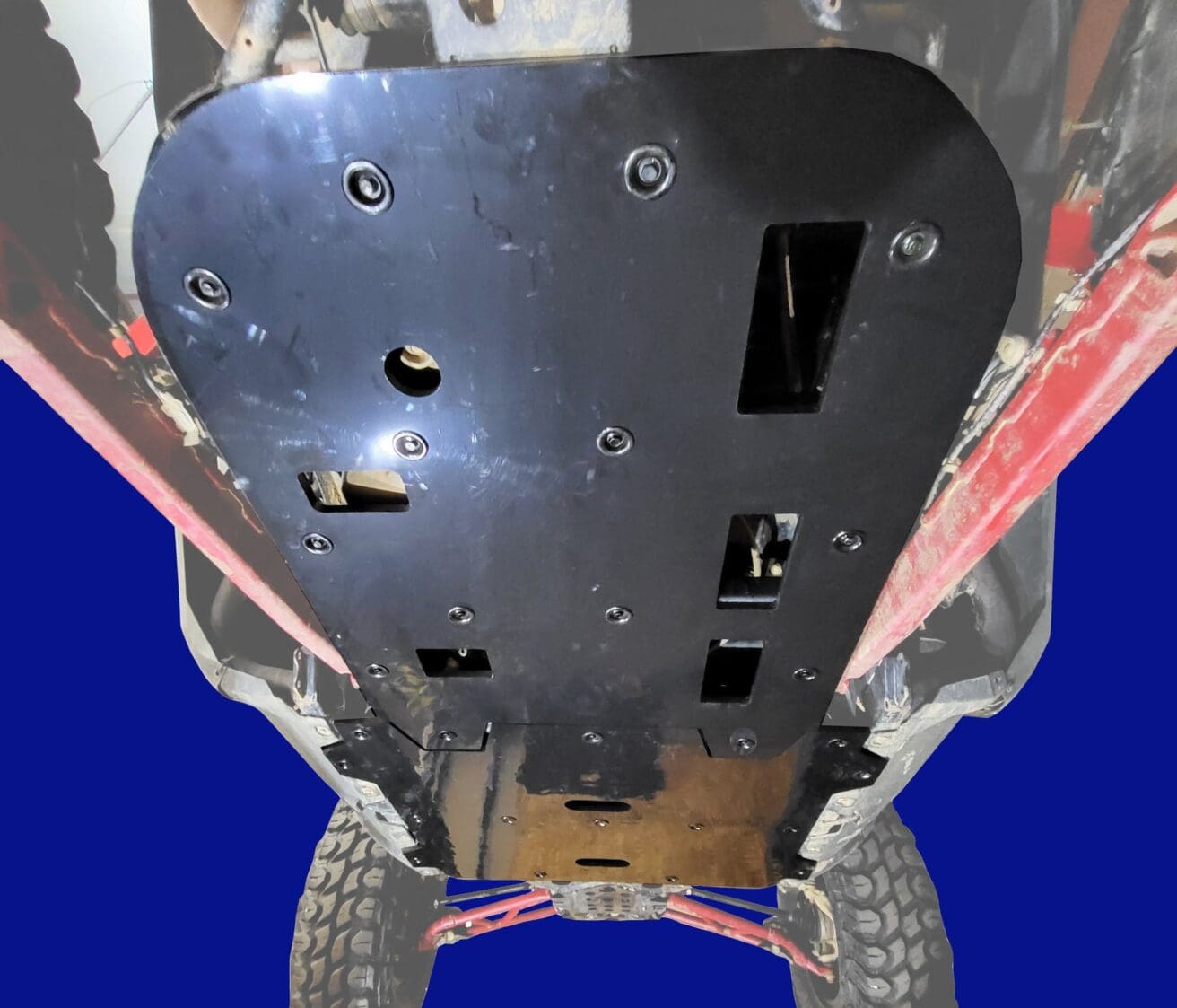 Vehicle undercarriage with protective skid plate.