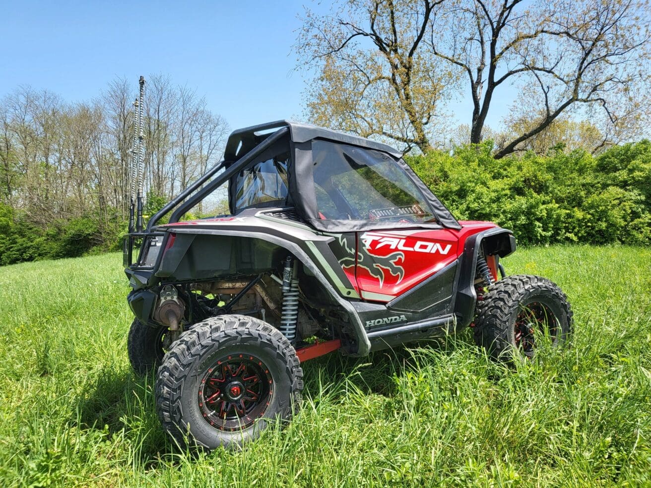 Off-road vehicle in grassy field.