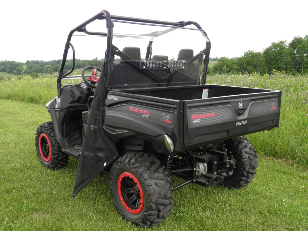 Off-road utility vehicle on grassy field.