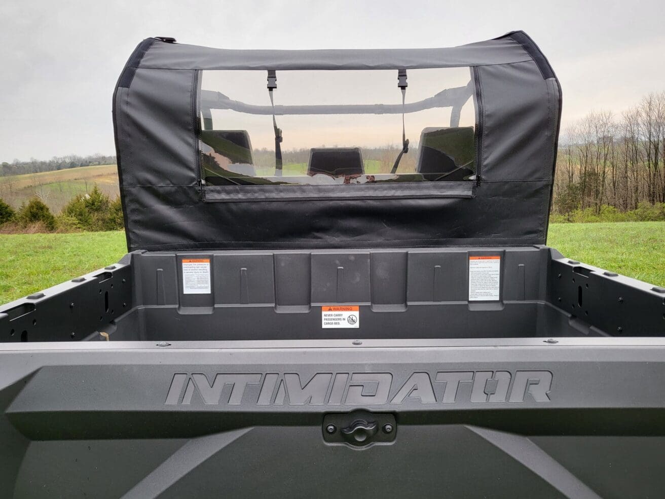 Open truck bed with black cover outdoors.