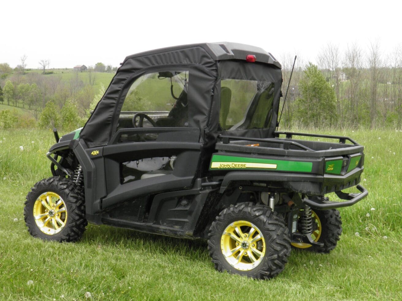 Utility vehicle with canopy in grassy field.